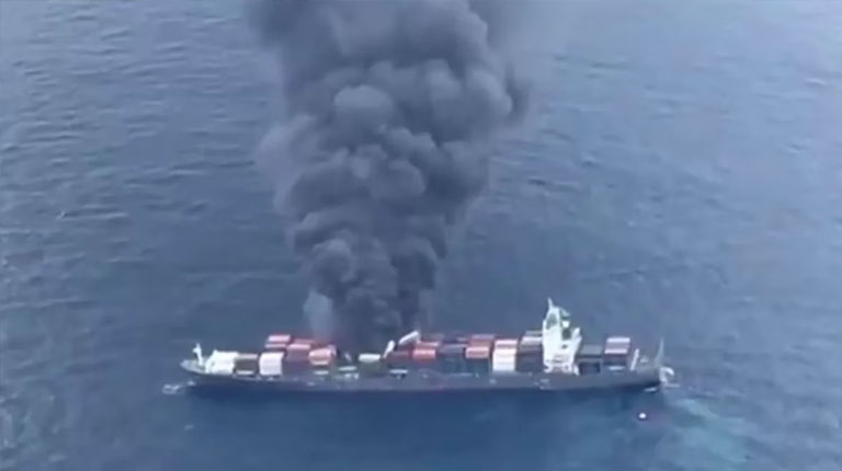 Smoke billows from Singapore-flagged vessel in Indian Ocean